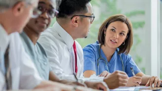 A Resident speaks with Hospital Staff