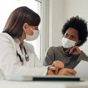 Doctor Speaking With Patients About Treatment with Masks