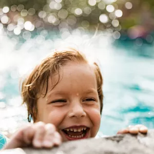 Boy swimming in pool.