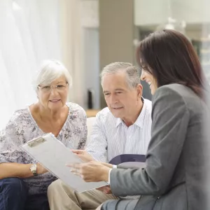 Two older patients talking to a transplant coordinator