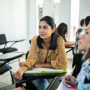 Girl Working With Group of Students