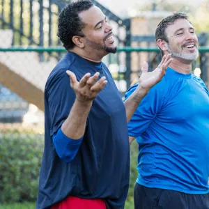 Group of men staying healthy playing basketball