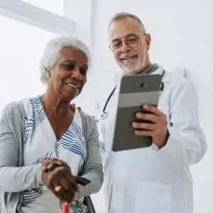 Senior woman patient talking with male doctor.