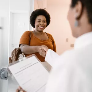 Woman shaking her doctor's hand.