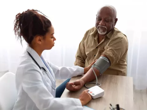 A Physician Checks Her Patient's Blood Pressure