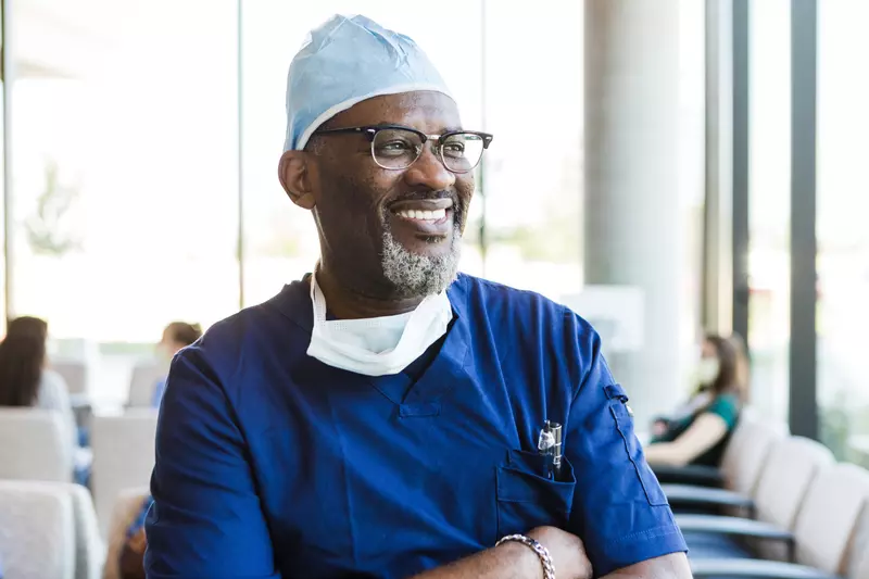 A Doctor Smiles as He Reflects on a Job Well Done.