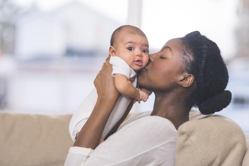 Mother Holding and Kissing Baby
