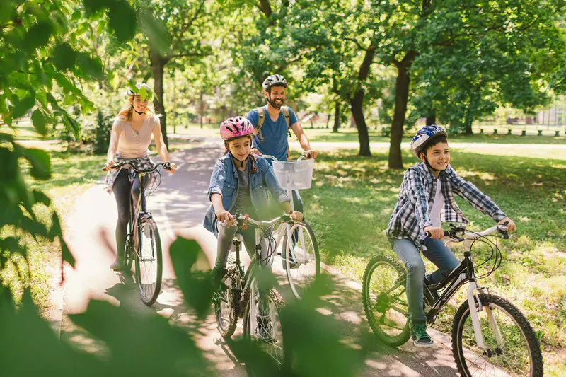 A family on a bike ride at a park