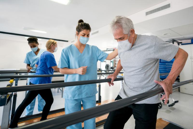 Nurse Helping Patient with Rehabilitation Exercise