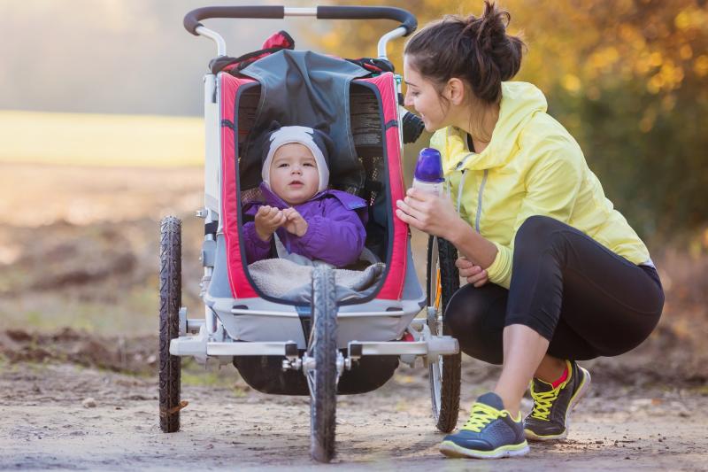 Mom Walking in Park With Baby in Stroller