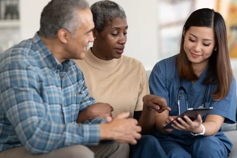 An older couple reviews their test results with their doctor.