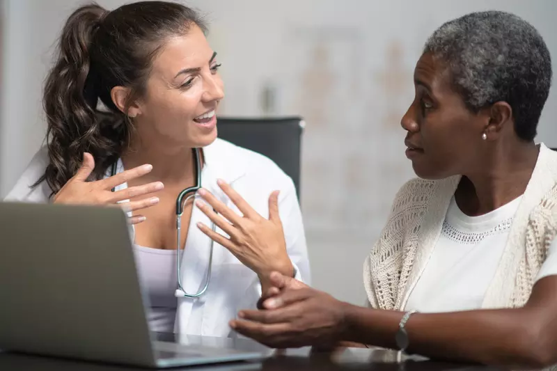 A woman reviews her test results with her doctor.