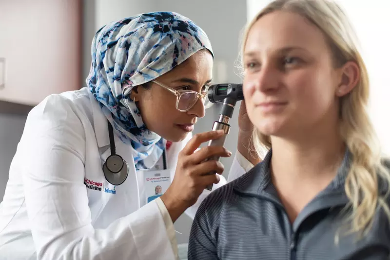 Physician Checking Patient's Earlobes