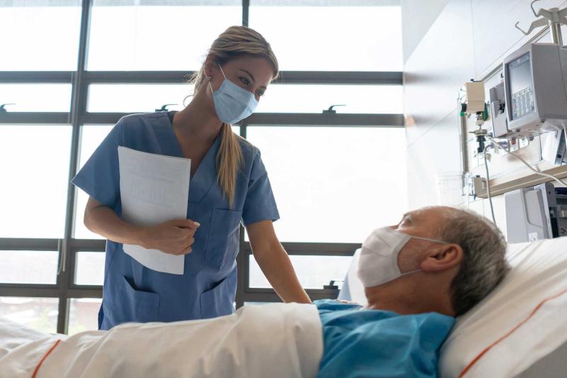 Nurse Checks on an Patient in His Hospital Room.