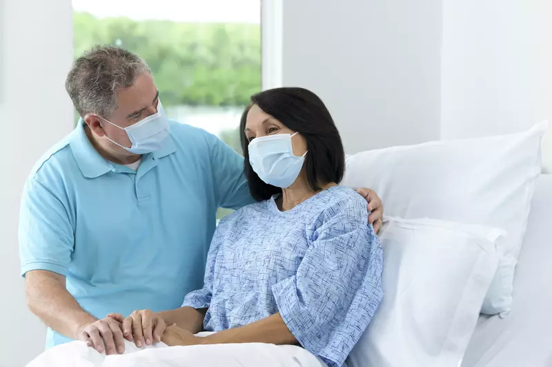 Patient with Family visitor in hospital bed