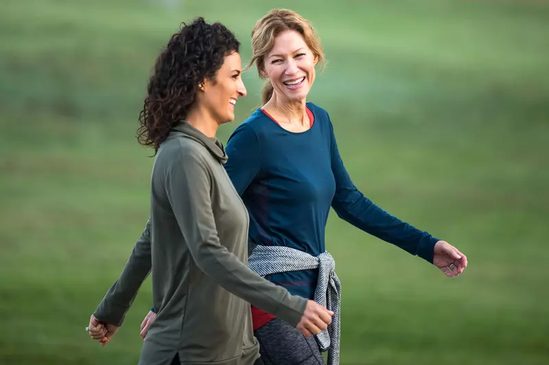 Two Women Walking and Smiling