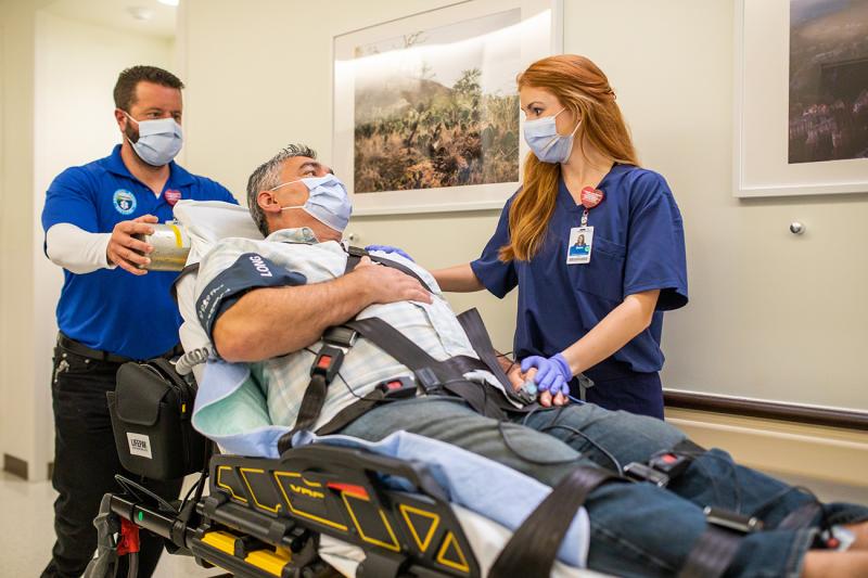 Patient in Stretcher Being Taken into ER Room