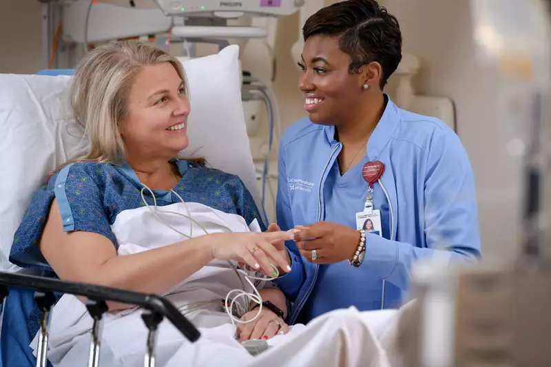 UChicago Medicine AdventHealth Nurse Helping Patient in Hospital