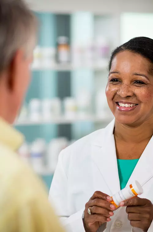 Pharmacist Smiling at Customer