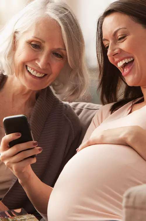 Pregnant Woman With Mom Looking at Phone